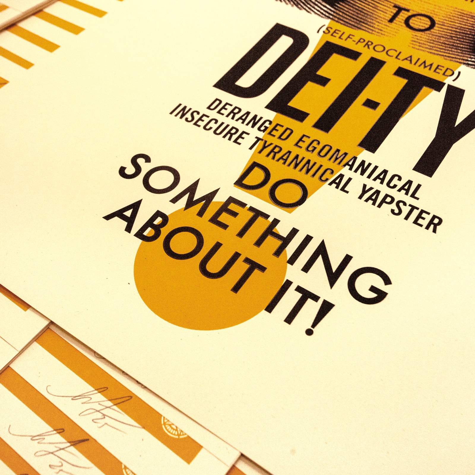 A close-up of the bottom right of a poster with text: DEITY DERANGED EGOMANIACAL INSECURE TYRANNICAL YAPSTER DO SOMETHING&hellip;