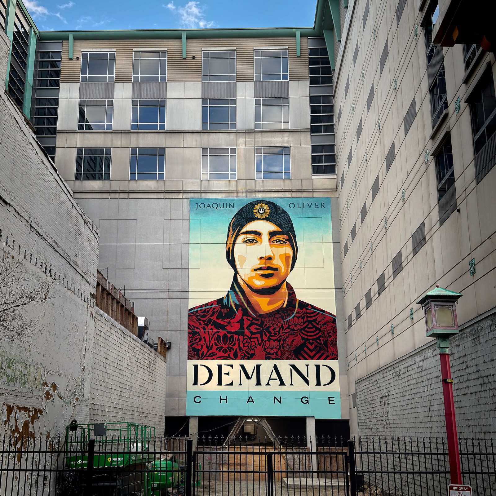 A large mural of Joaquin Oliver with text