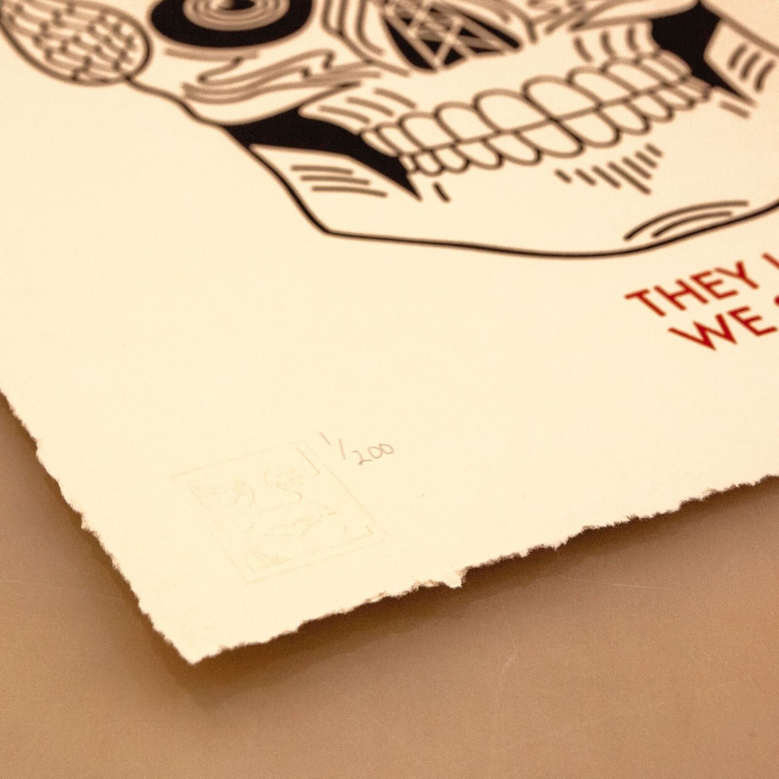 Stylized skull print; They lie, we see text; numbered 11/200.