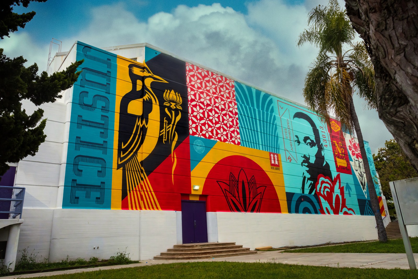 A vibrant mural on a building featuring a bird, Martin Luther King Jr.'s portrait, and various patterns in red, blue&hellip;