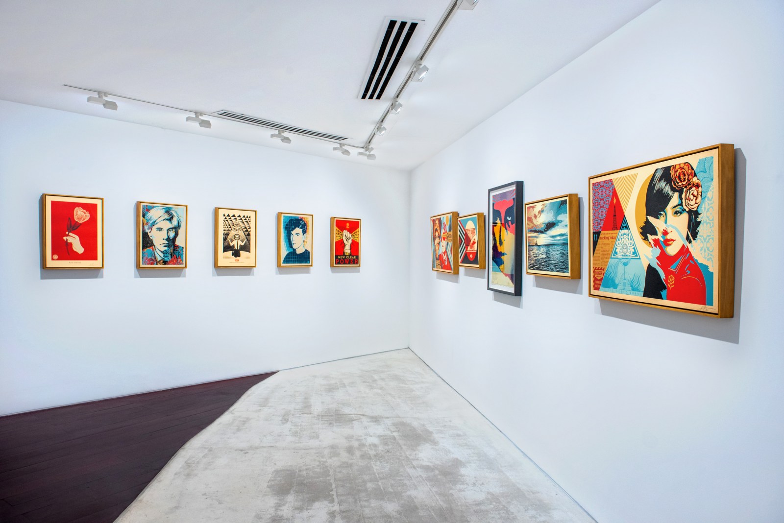 An art gallery wall displaying various pop art prints, including portraits of Andy Warhol and other figures, in vibrant&hellip;