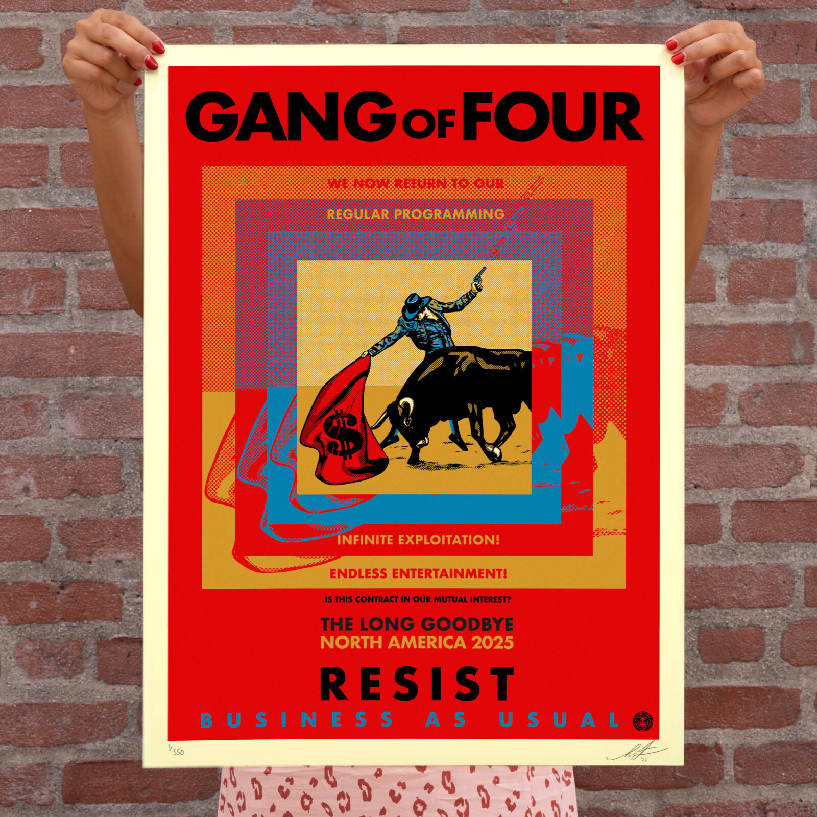 A person holds a red, yellow, and blue poster for "GANG of FOUR" with a bullfighter and bull, and text: "WE NOW RETURN TO&hellip;