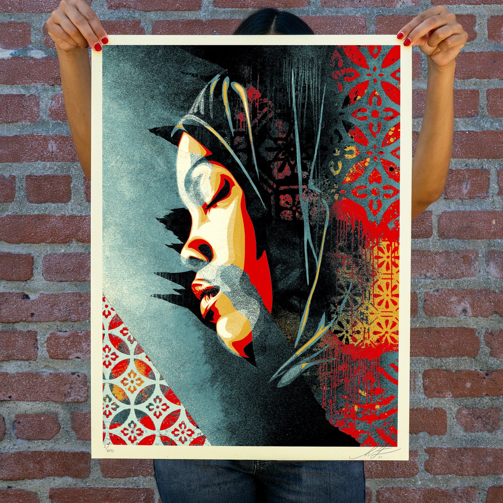 A person holds a poster featuring a woman's profile in red, black, and blue, with intricate patterns and textures.